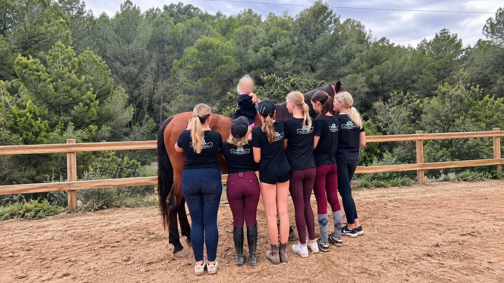 Paradise Stables team and members with a horse